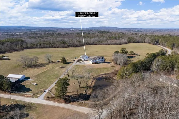 a spacious bathroom with double vanity sink a mirror and a shower