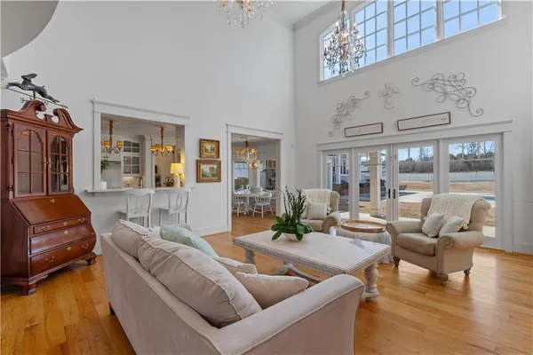 a view of a dining room with furniture and a chandelier