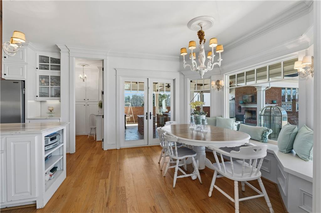 31 Duck Pond Road Roopville, GA 30170 - Photo 44 of 136 a dining room with wooden floor a chandelier a wooden table and chairs