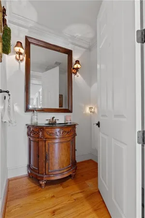 a kitchen with stainless steel appliances kitchen island granite countertop a dining table chairs and a refrigerator