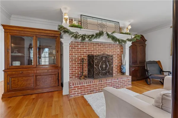 a kitchen with stainless steel appliances kitchen island granite countertop a dining table chairs refrigerator and cabinets