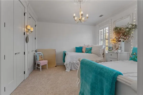 a living room with stainless steel appliances furniture a rug and a window