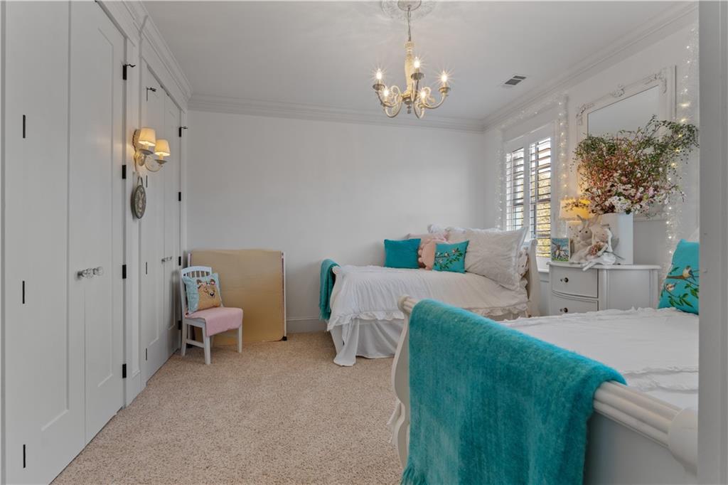 31 Duck Pond Road Roopville, GA 30170 - Photo 72 of 136 a spacious bedroom with a bed and a chandelier