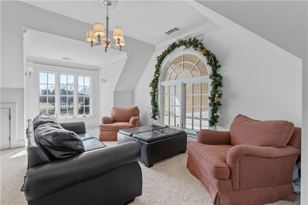 31 Duck Pond Road Roopville, GA 30170 - Photo 79 of 136 a living room with furniture a large window and a chandelier