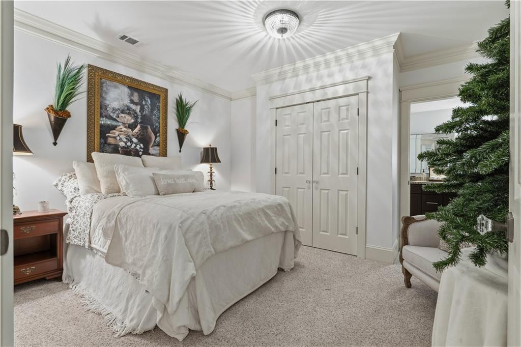 31 Duck Pond Road Roopville, GA 30170 - Photo 90 of 136 a spacious bedroom with a bed and a painting on the wall