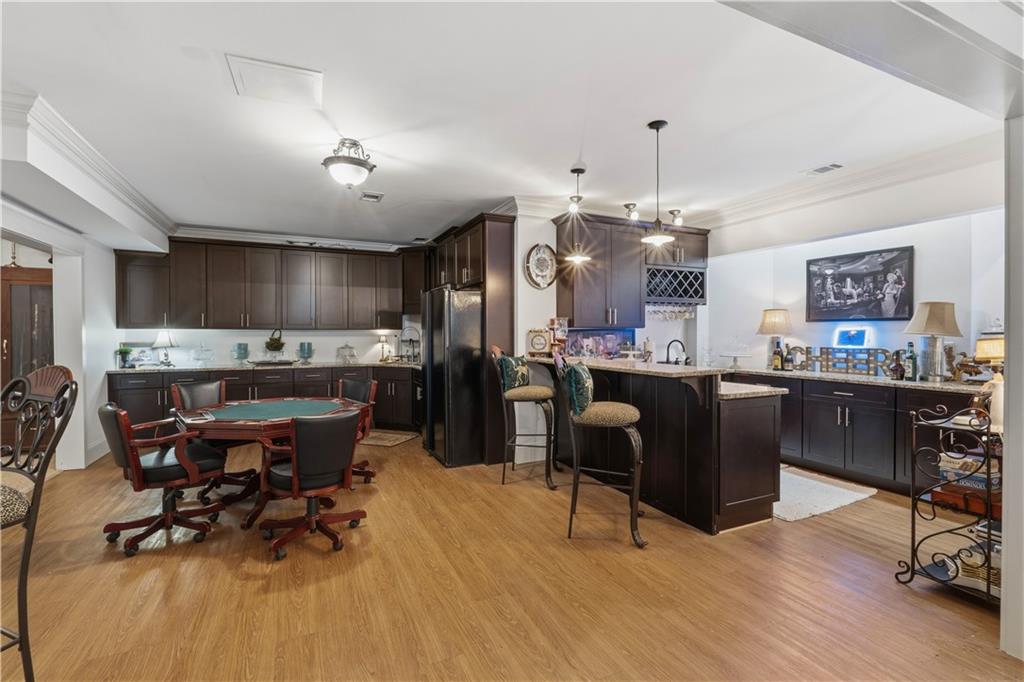 31 Duck Pond Road Roopville, GA 30170 - Photo 94 of 136 a kitchen with stainless steel appliances kitchen island granite countertop a dining table chairs and a refrigerator