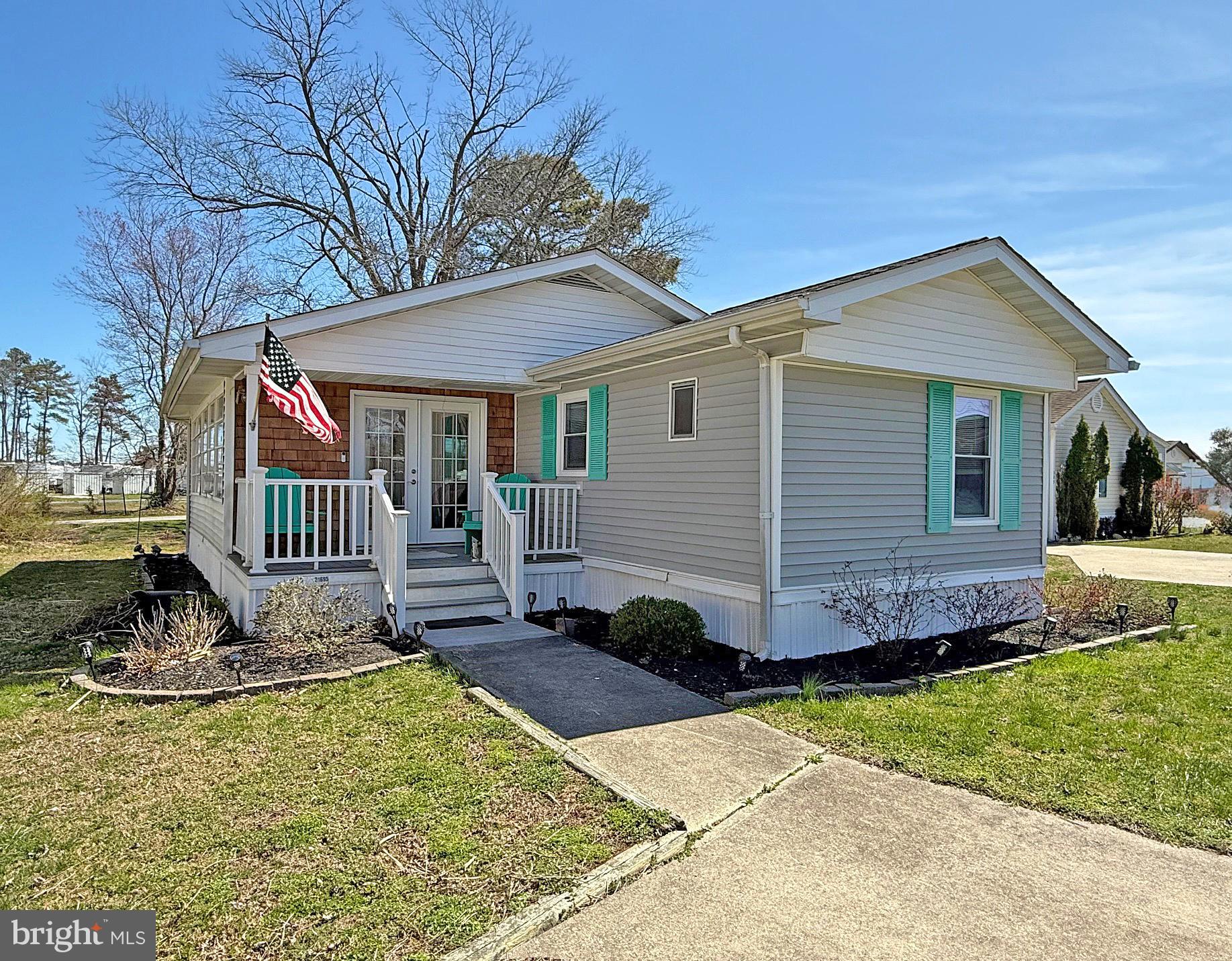21695 F Street, Unit F40 Rehoboth Beach, DE 19971 - Photo 1 of 29 a front view of a house with a yard
