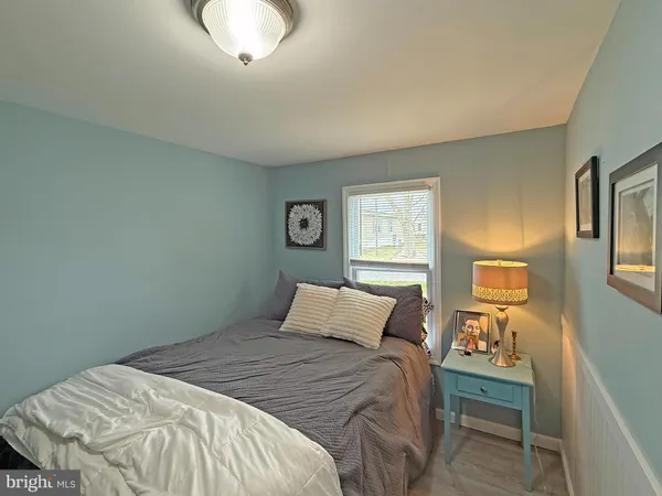 a bedroom with a bed and a lamp