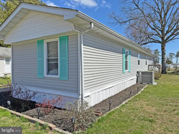 a sign board with buildings in the background