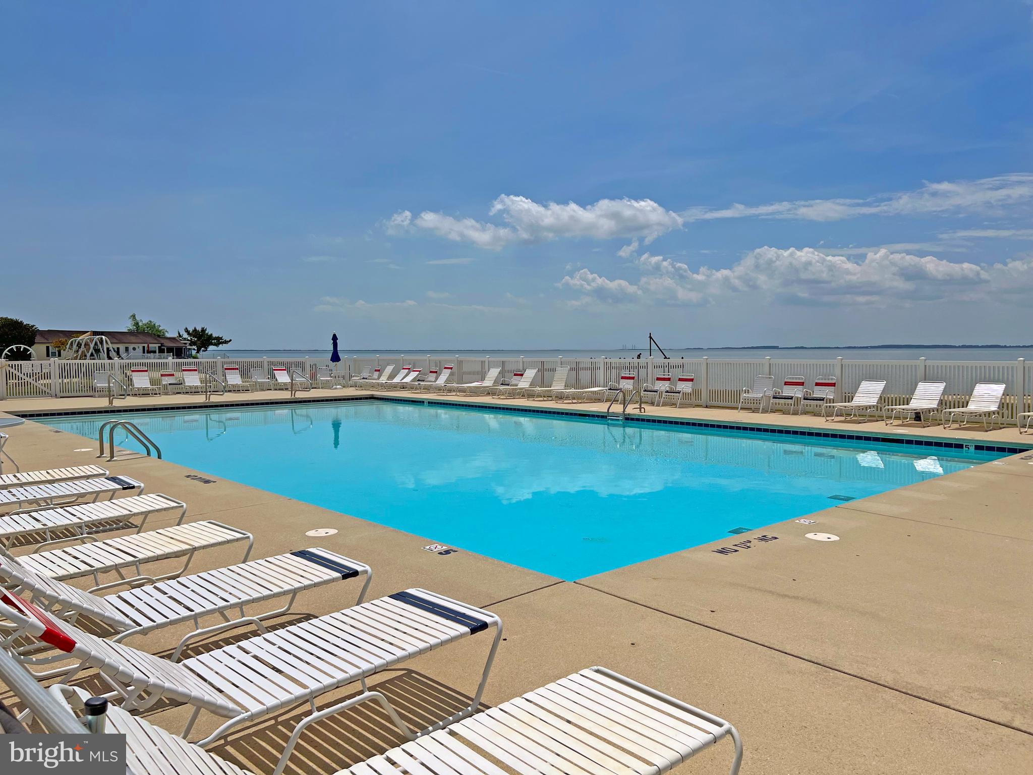 21695 F Street, Unit F40 Rehoboth Beach, DE 19971 - Photo 25 of 29 a view of a swimming pool and an outdoor seating