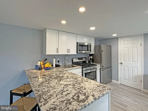 a kitchen with refrigerator and cabinets