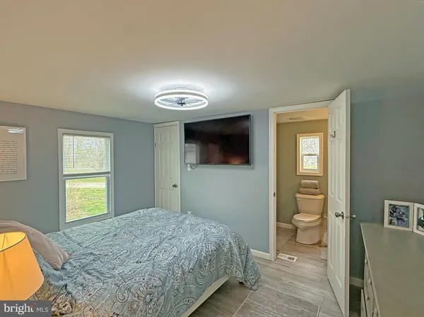 a bedroom with a bed and a television