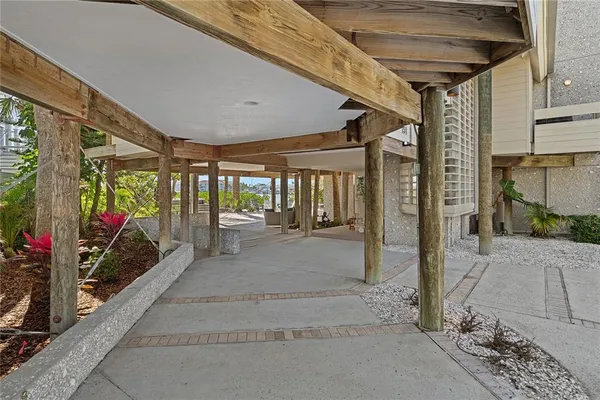 a view of a patio with table and chairs and wooden floor