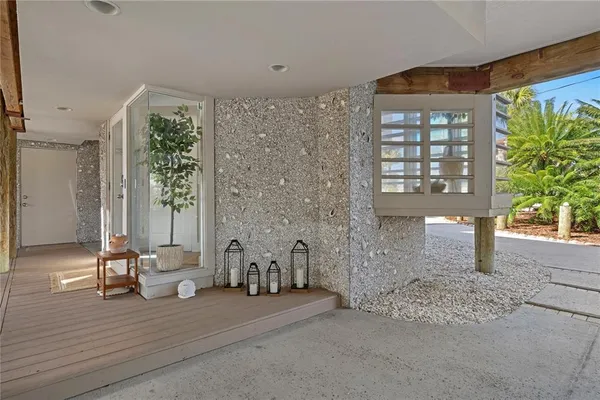 a view of a chairs and table in the balcony