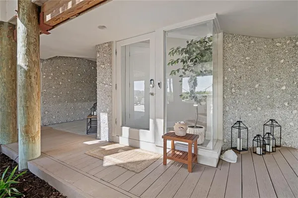a dining room with furniture potted plants and wooden floor