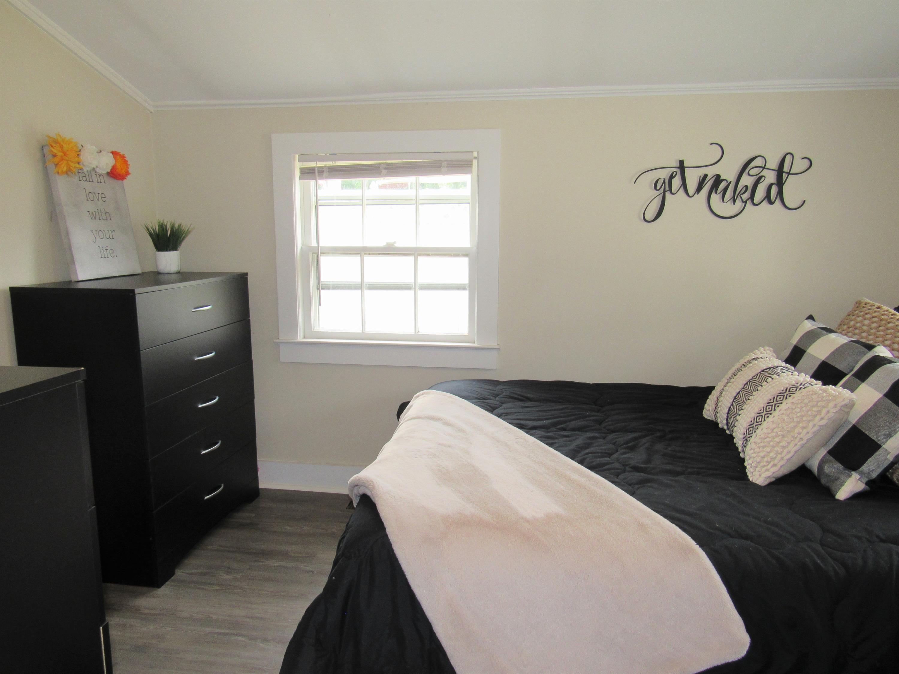 103 Baxter Road Hyannis, MA 02601 - Photo 16 of 31 a bedroom with a bed and wooden floor