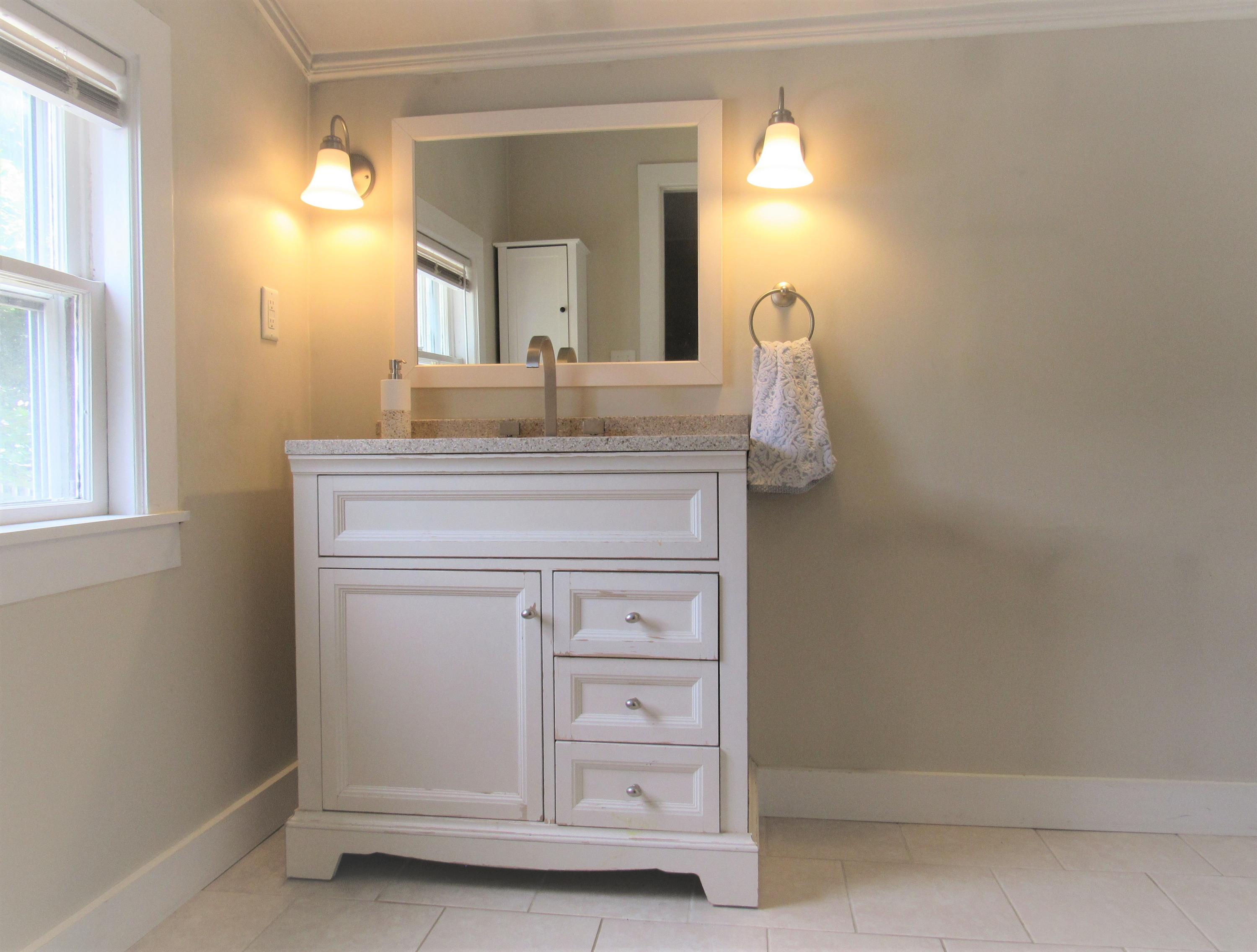103 Baxter Road Hyannis, MA 02601 - Photo 18 of 31 a bathroom with a sink vanity and a mirror