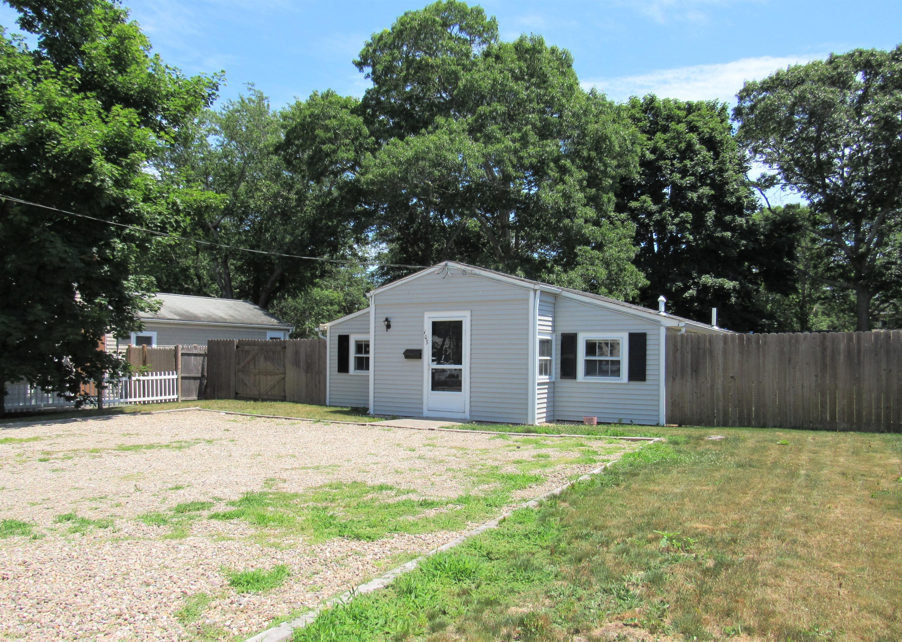 103 Baxter Road Hyannis, MA 02601 - Photo 2 of 31 a front view of house with yard and trees in the background