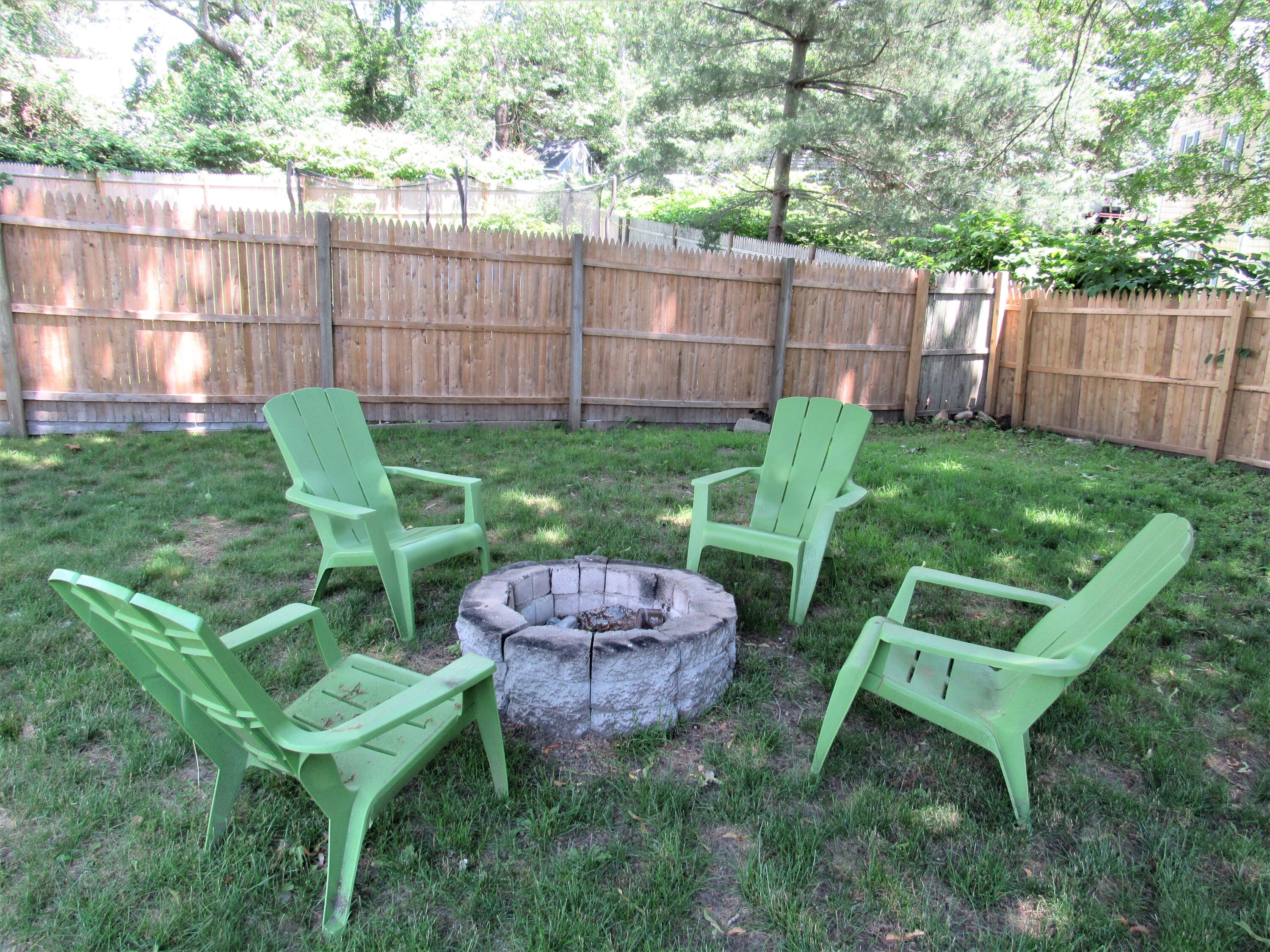 103 Baxter Road Hyannis, MA 02601 - Photo 24 of 31 a view of a chair and tables in the backyard
