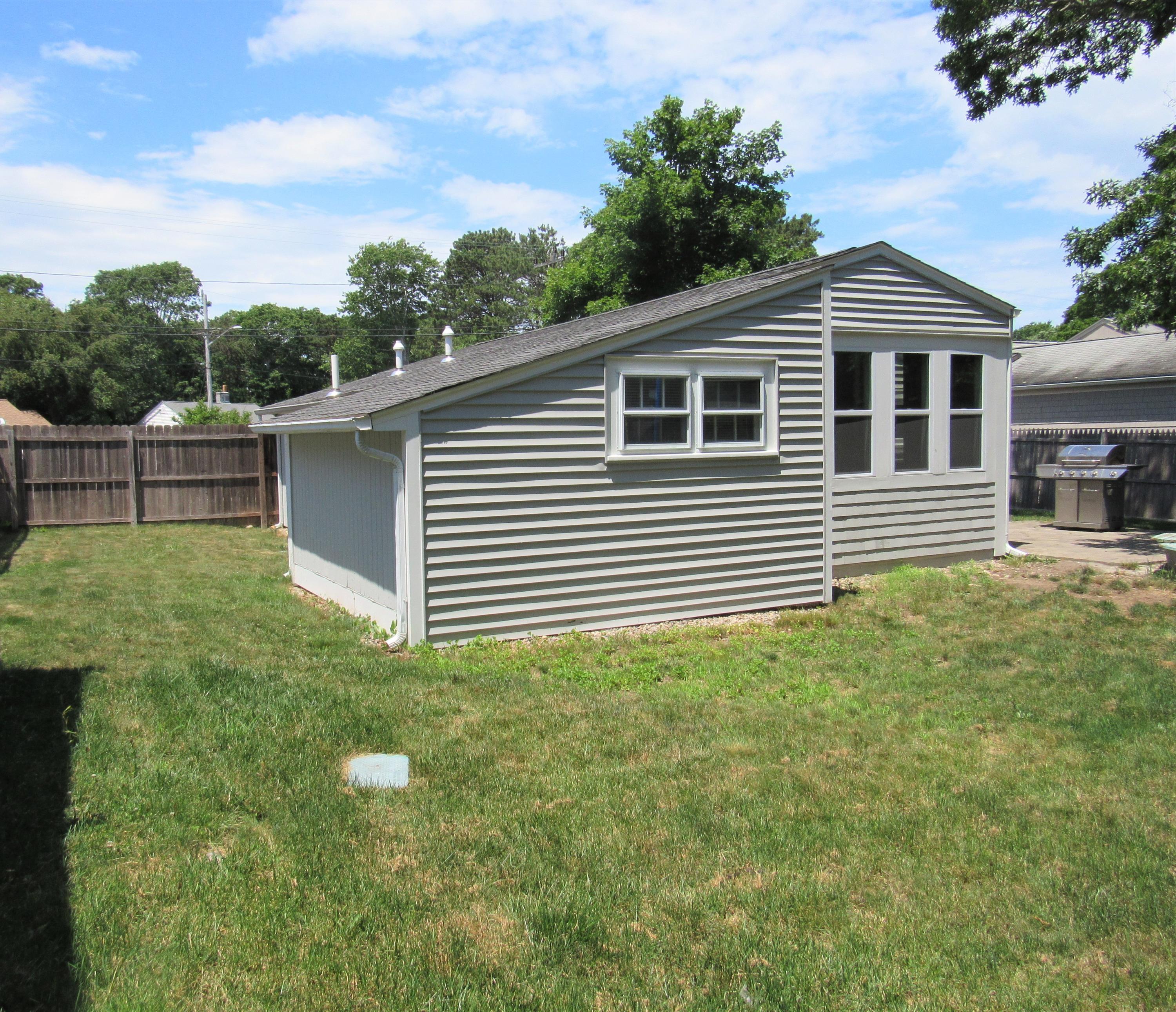 103 Baxter Road Hyannis, MA 02601 - Photo 29 of 31 a front view of a house with a yard