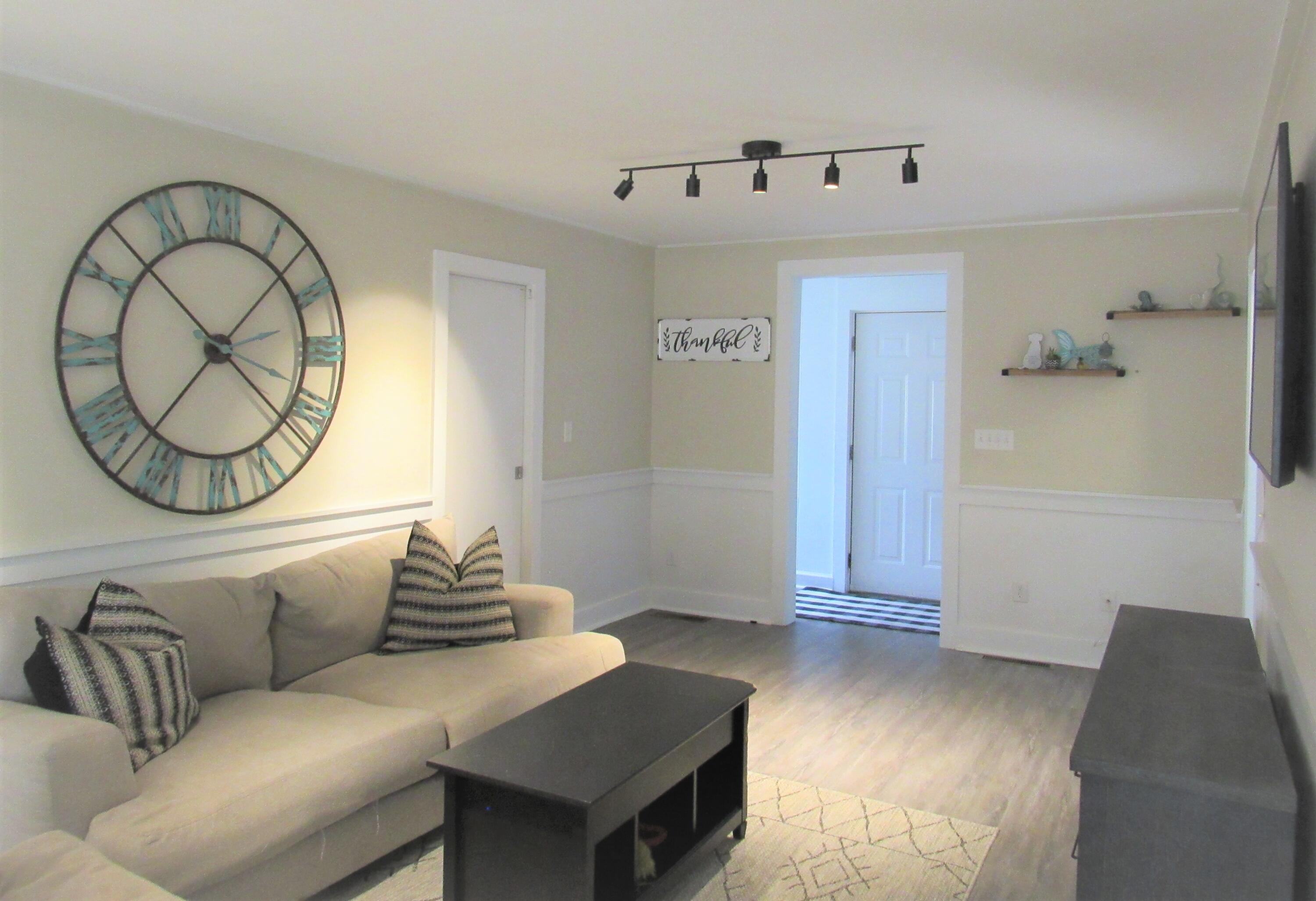 103 Baxter Road Hyannis, MA 02601 - Photo 6 of 31 a living room with a couch and a mirror