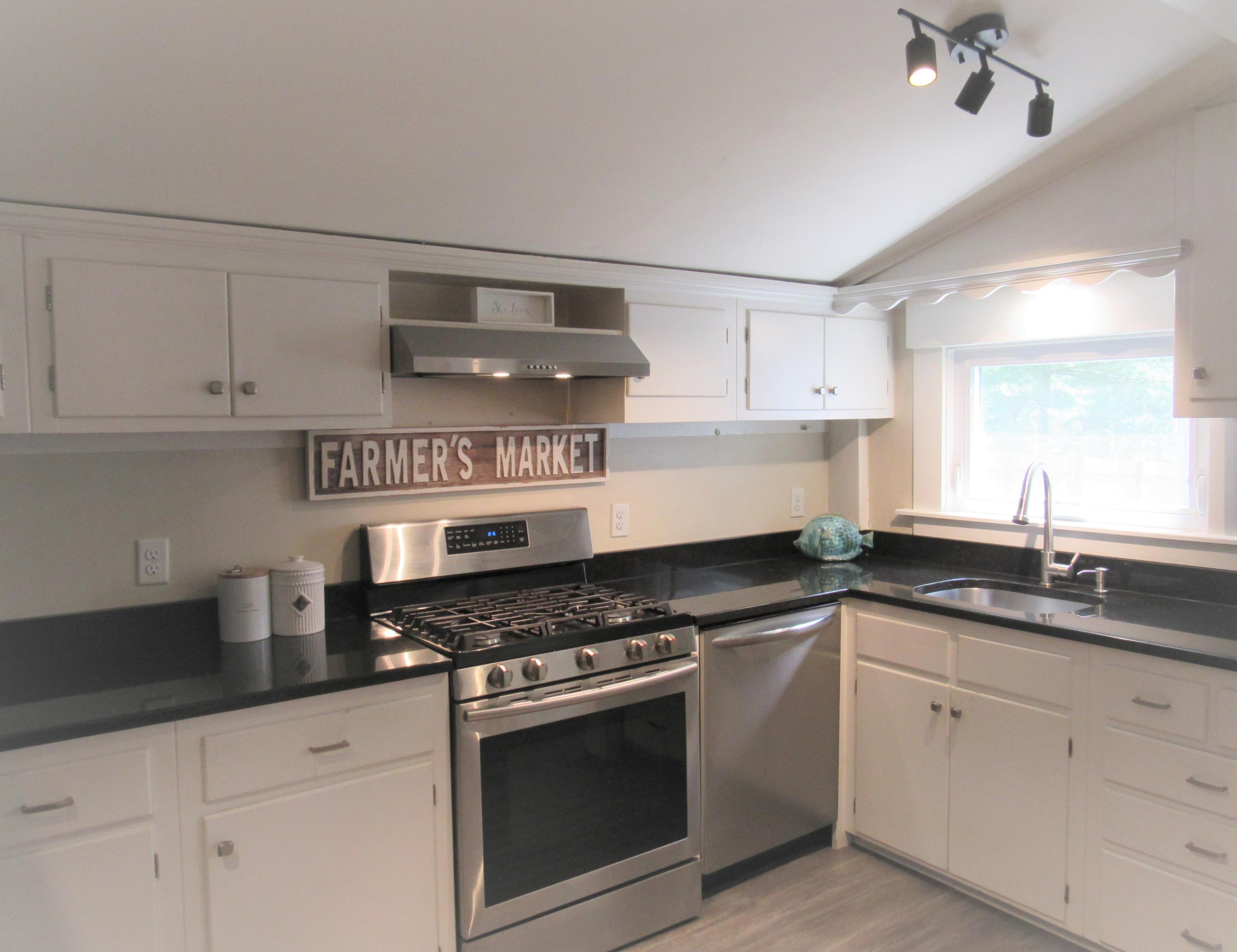103 Baxter Road Hyannis, MA 02601 - Photo 10 of 31 a kitchen with granite countertop white cabinets and appliances
