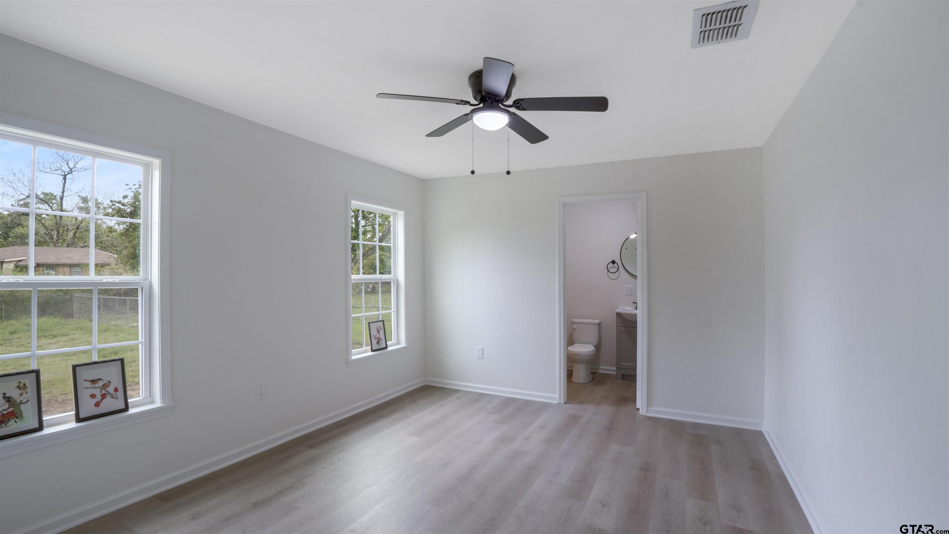 1925 Cushing Drive Tyler, TX 75702 - Photo 11 of 30 a view of an empty room with a window and wooden floor