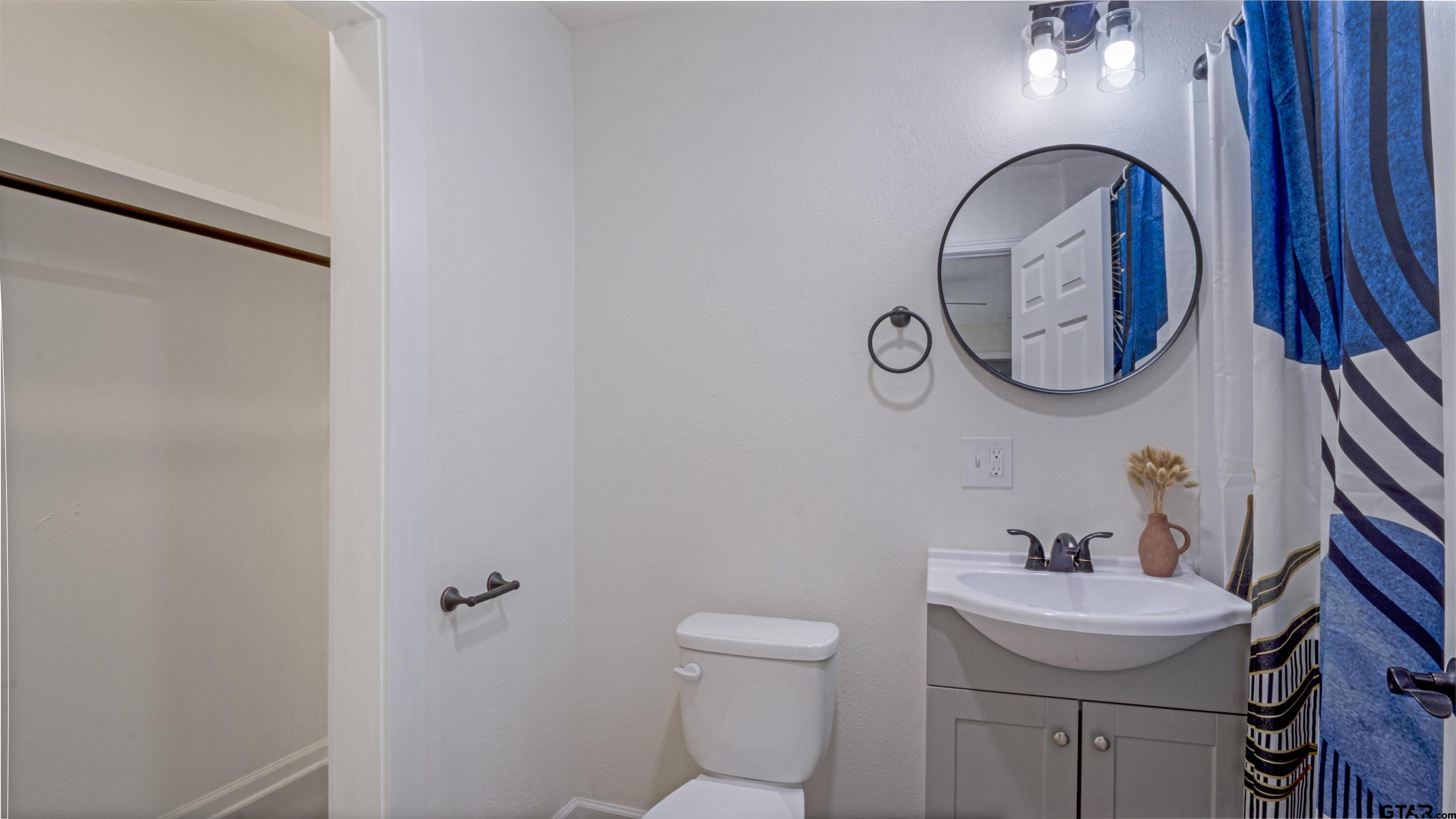 1925 Cushing Drive Tyler, TX 75702 - Photo 12 of 30 a bathroom with a sink and mirror with toilet