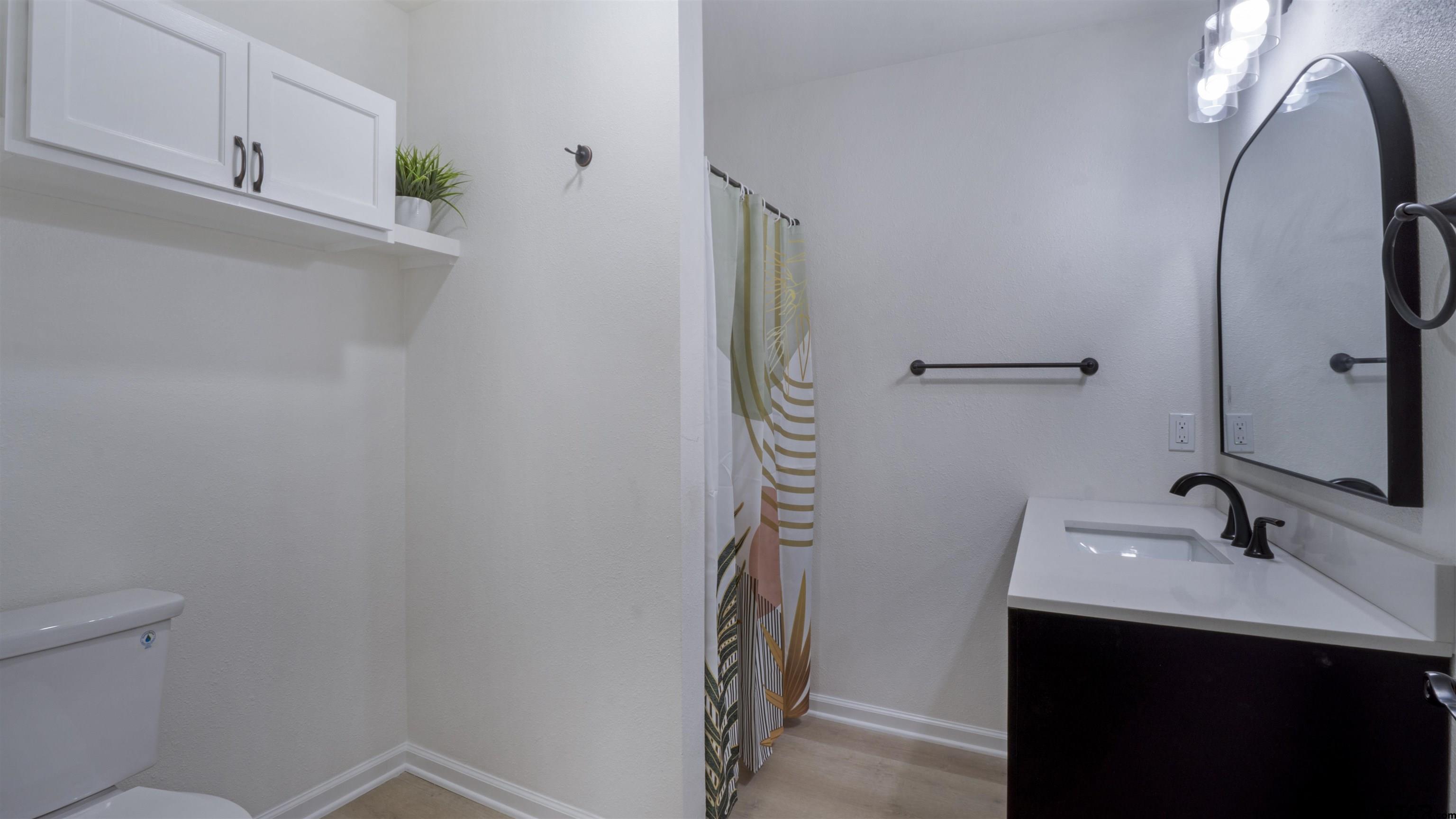 1925 Cushing Drive Tyler, TX 75702 - Photo 15 of 30 a bathroom with a sink a toilet and mirror