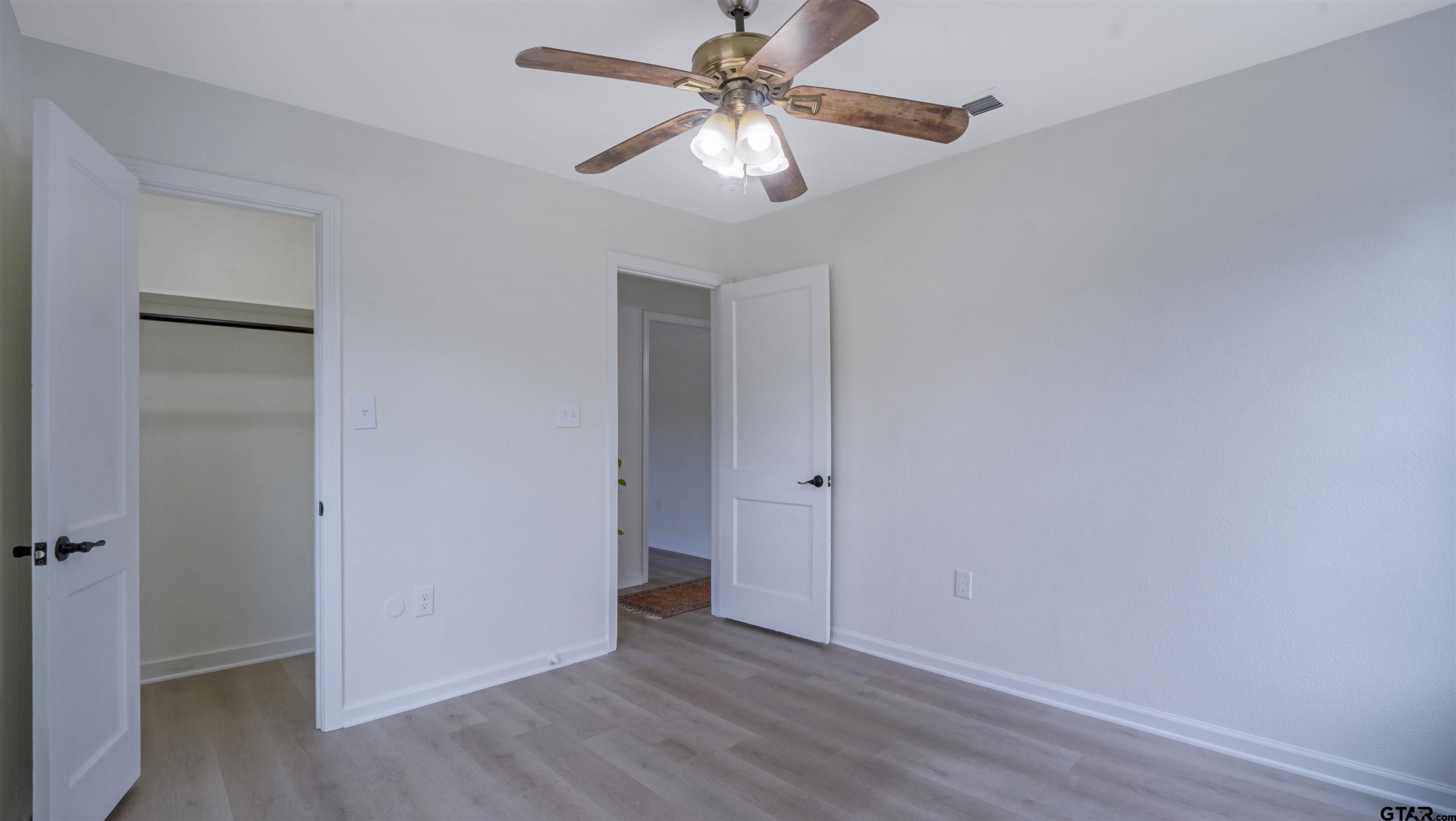 1925 Cushing Drive Tyler, TX 75702 - Photo 18 of 30 a view of an empty room with window and wooden floor