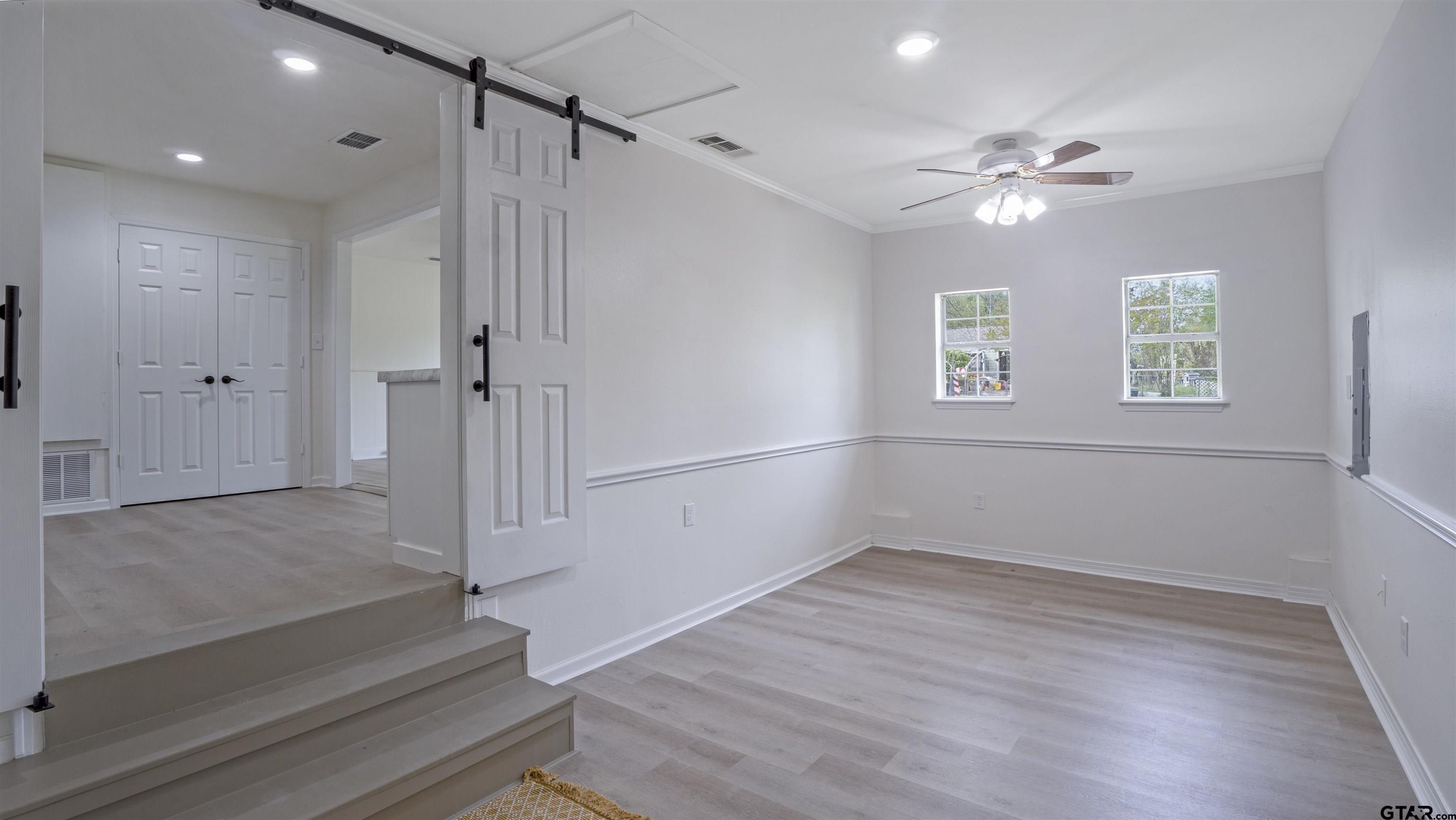 1925 Cushing Drive Tyler, TX 75702 - Photo 22 of 30 a view of an empty room with wooden floor and a window