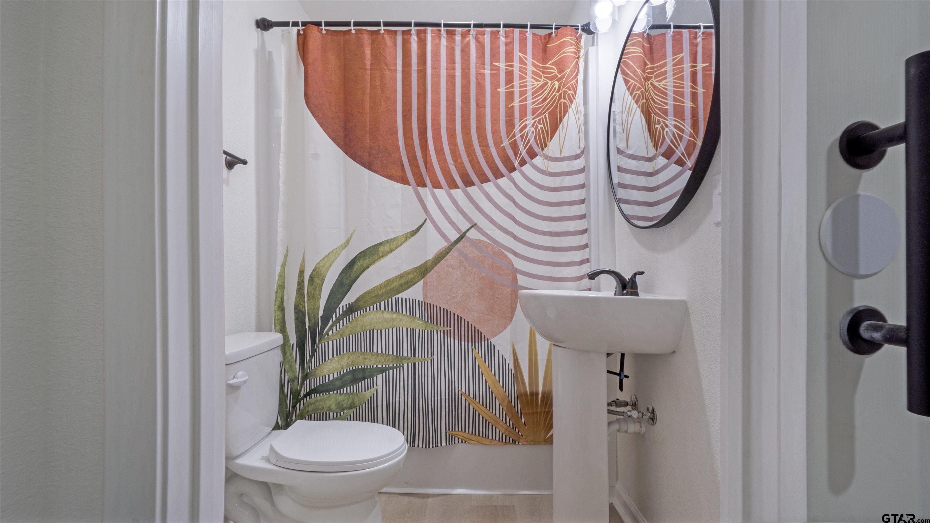 1925 Cushing Drive Tyler, TX 75702 - Photo 24 of 30 a bathroom with a toilet and a sink