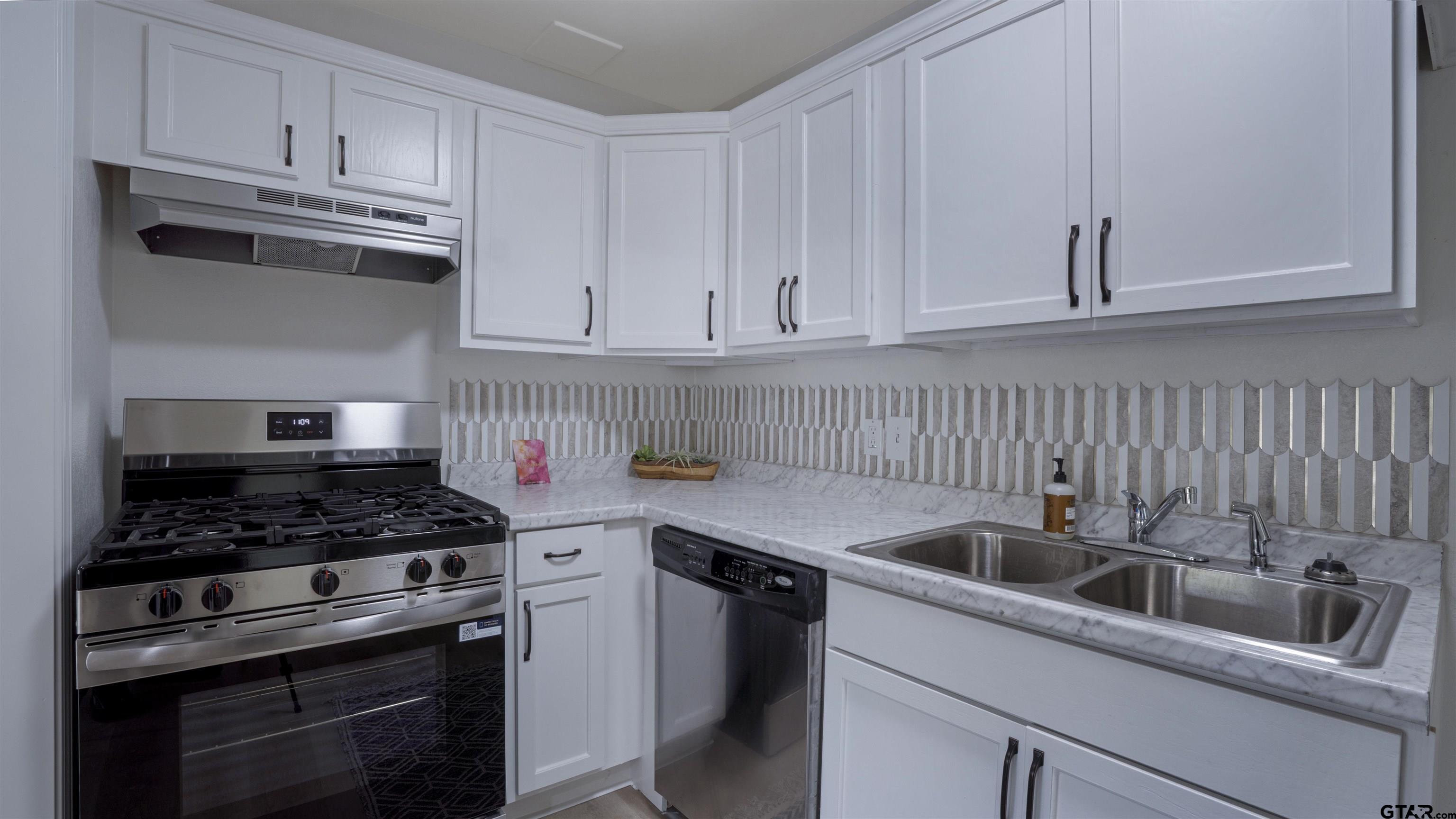 1925 Cushing Drive Tyler, TX 75702 - Photo 9 of 30 a kitchen with cabinets appliances and a sink