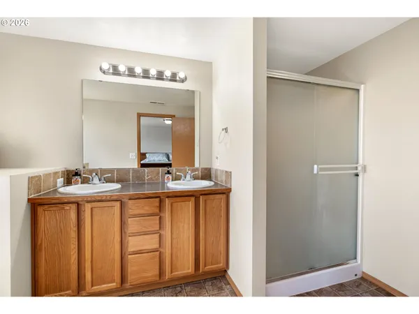 a bathroom with a bathtub a mirror a double vanity sinks and vanity