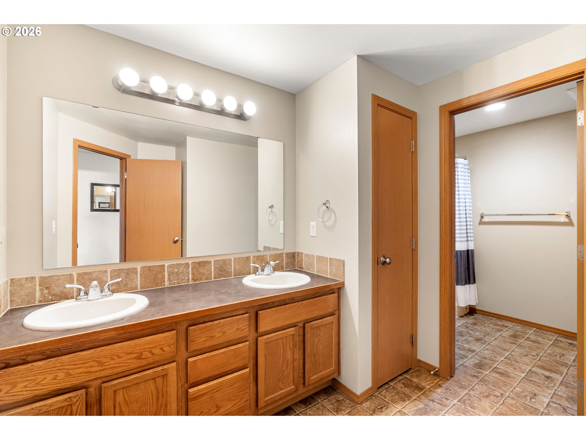 100 Grace Way Goldendale, WA 98620 - Photo 15 of 48 a bathroom with a granite countertop sink a mirror and a shower