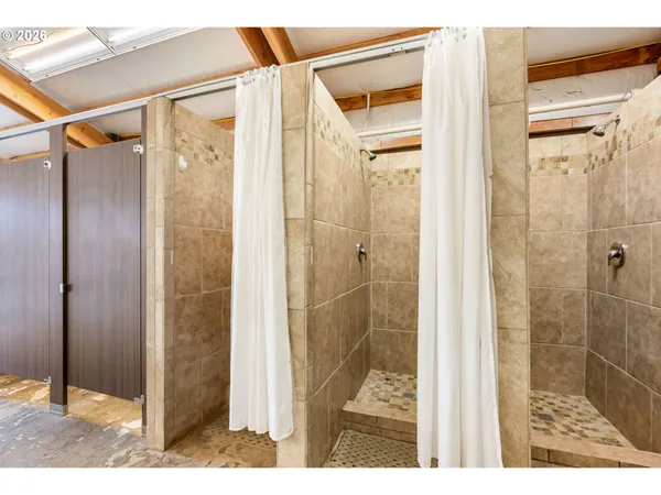 a view of backyard of house with wooden fence