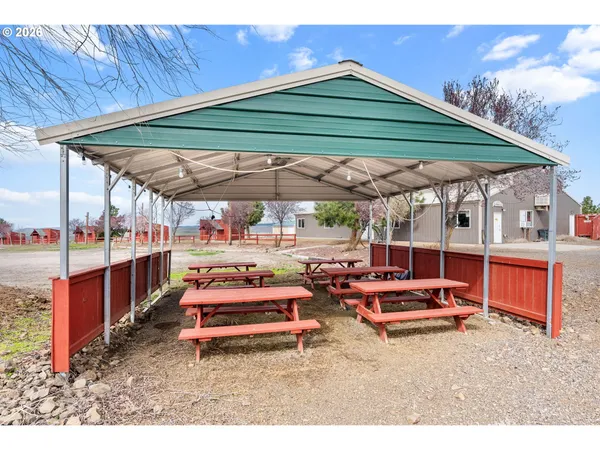 a backyard of a house with barbeque oven table and chairs