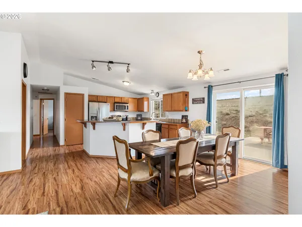 a view of a dining room with furniture and wooden floor