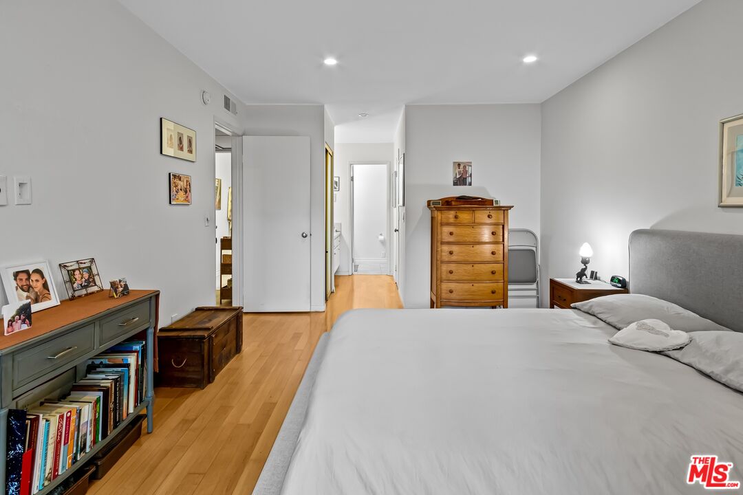 8103 Raintree Circle Culver City, CA 90230 - Photo 17 of 35 a bedroom with a bed and a book shelf