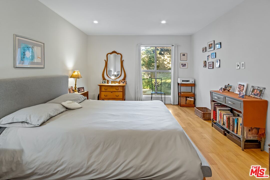 8103 Raintree Circle Culver City, CA 90230 - Photo 18 of 35 a bedroom with a bed a dresser next to a window