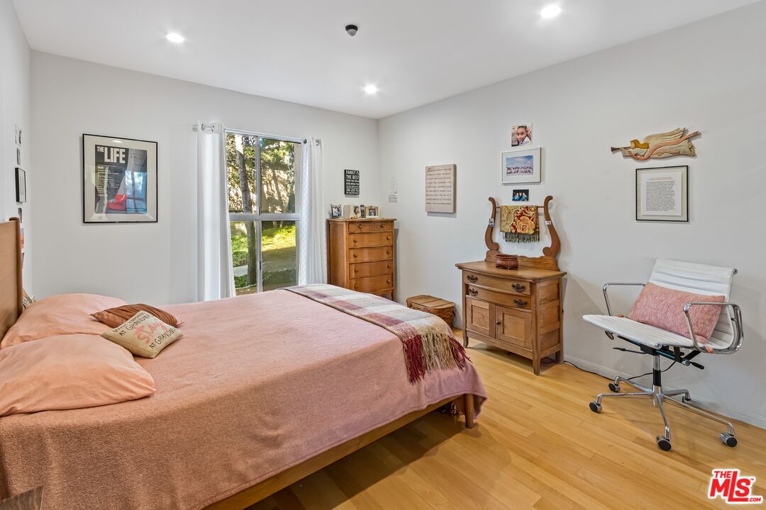 8103 Raintree Circle Culver City, CA 90230 - Photo 21 of 35 a bedroom with a bed and wooden floor