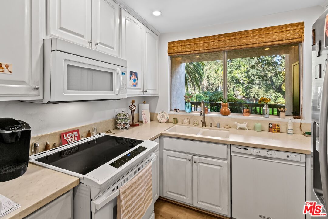 8103 Raintree Circle Culver City, CA 90230 - Photo 22 of 35 a kitchen with appliances cabinets and a sink