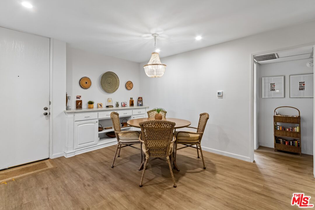 8103 Raintree Circle Culver City, CA 90230 - Photo 26 of 35 a view of a dining room with furniture and wooden floor