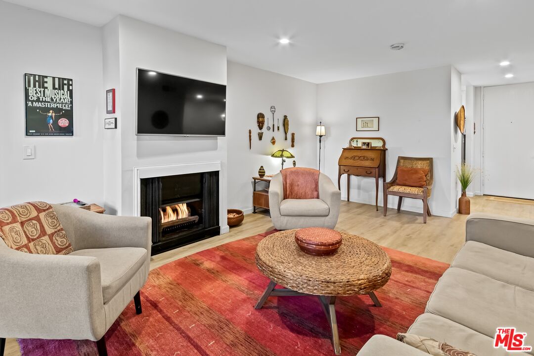 8103 Raintree Circle Culver City, CA 90230 - Photo 27 of 35 a living room with furniture a flat screen tv and a fireplace