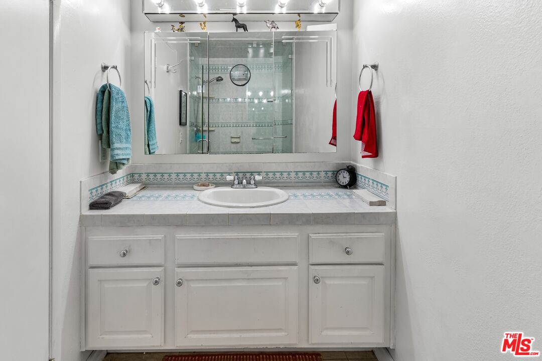 8103 Raintree Circle Culver City, CA 90230 - Photo 32 of 35 a bathroom with a sink vanity and a mirror