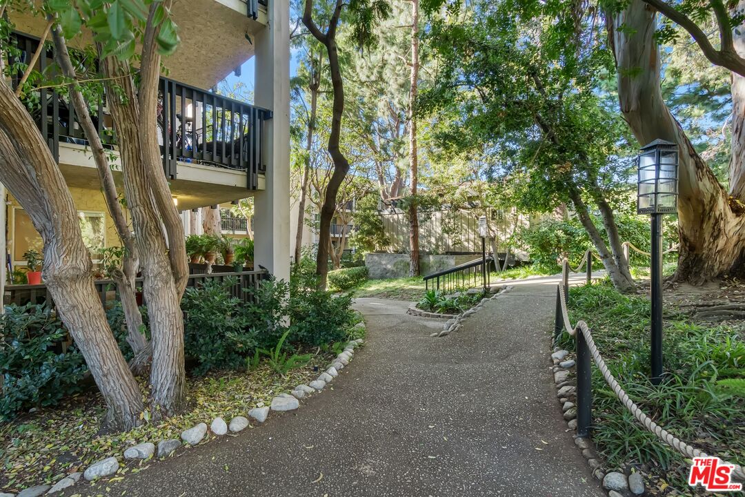 8103 Raintree Circle Culver City, CA 90230 - Photo 7 of 35 a view of a pathway of a house with large trees