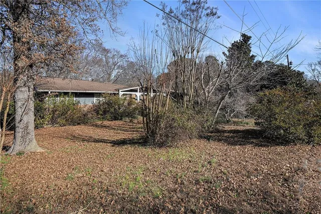 a view of a yard with wooden fence