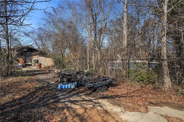 a backyard of a house with barbeque oven table and chairs
