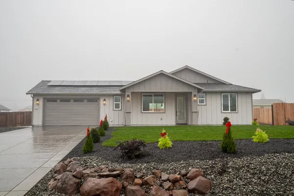 a front view of a house with a yard and garage
