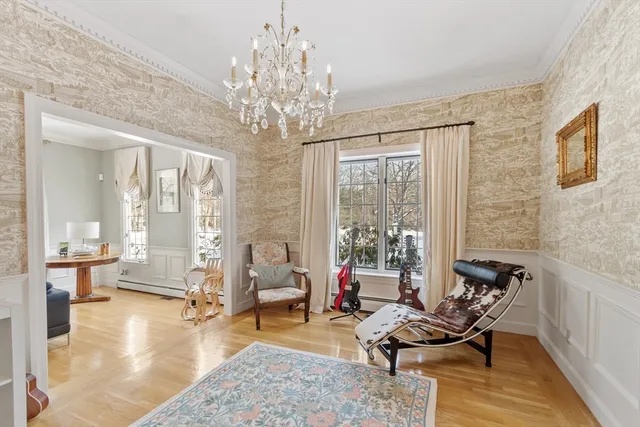 a living room with furniture and a chandelier